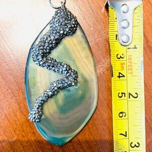 Dramatic semi-precious stone pendant with sparkling rhinestones like a snake